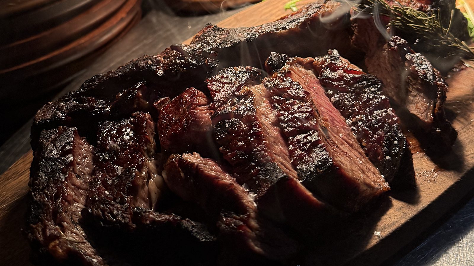 The asado fire at Renzo's — where the family-style grill platters for private events in Carrollwood are cooked